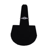 Silver ring on a black velvet display stand against a white background