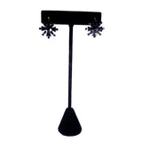 Black floral earrings on a black T-shaped earring stand against a white background