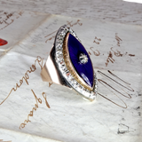 Silver ring with a blue gemstone on an old letter background