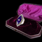 Ring with purple stone and diamond in a purple velvet box