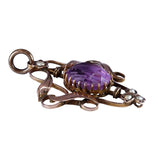 Decorative pendant with a purple gemstone on a white background