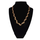 Gold chain necklace on a black mannequin bust