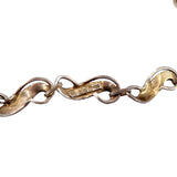 Close-up of a gold chain with visible hallmark on a white background