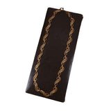 Gold chain necklace on a black stand against a white background