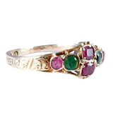 Gold ring with colored gemstones on a white background