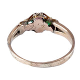 Gold ring with emeralds on a white background