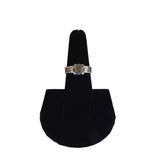 Silver ring on a black stand against a white background