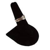 Silver ring on a black ring cushion against a white background