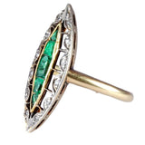 Gold ring with emerald and diamond accents on a white background