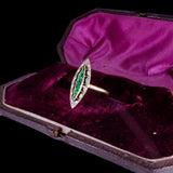 Vintage ring with emerald and diamond in a purple velvet box