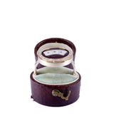 Open jewelry box with a ring inside on a white background