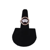 Ring with a card design on a black stand against a white background