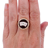 Ring with a unique design on a hand against a white background