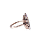 Silver ring with a central gemstone on a white background