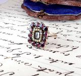 Vintage ring with gemstones on a piece of handwritten paper