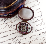 Vintage jewelry box with a decorative ring on an old letter