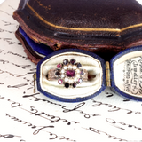 Vintage ring in an open jewelry box on an old document