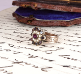 Vintage ring with gemstones on a piece of paper