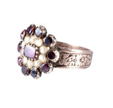 Silver ring with gemstones on a white background