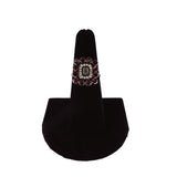 Decorative ring on a black stand against a white background