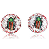 Pair of earrings with beetle design on a white background