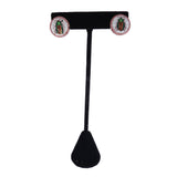 Pair of earrings on a black stand with a white background