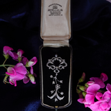 A vintage silver-toned brooch with floral scrollwork and clear stones, displayed inside an open black velvet jewelry box. The box lid is lined with cream satin and shows the brand 'Jewellers of Philadelphia' and address printed inside.