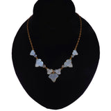 A gold-tone chain necklace with five light blue mother-of-pearl butterfly-shaped beads, displayed on a black neck mannequin against a white background.