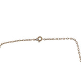 A close-up of a gold-toned chain necklace showing a lobster clasp and extension chain on a plain white background.