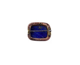 A vintage rectangular lapel pin featuring a deep blue lapis lazuli crystal inlay set in a coppery-bronze bezel with gold-toned metal hardware, shown against a plain white background.